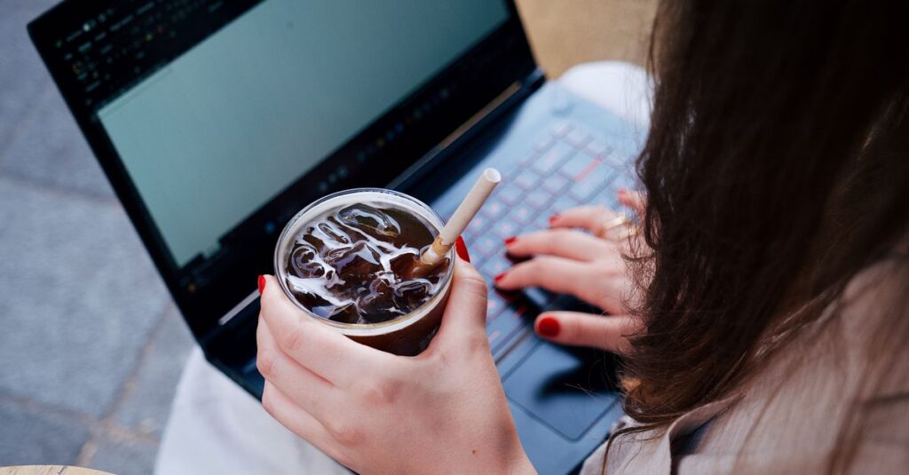 Person working on a laptop in a coffee shop