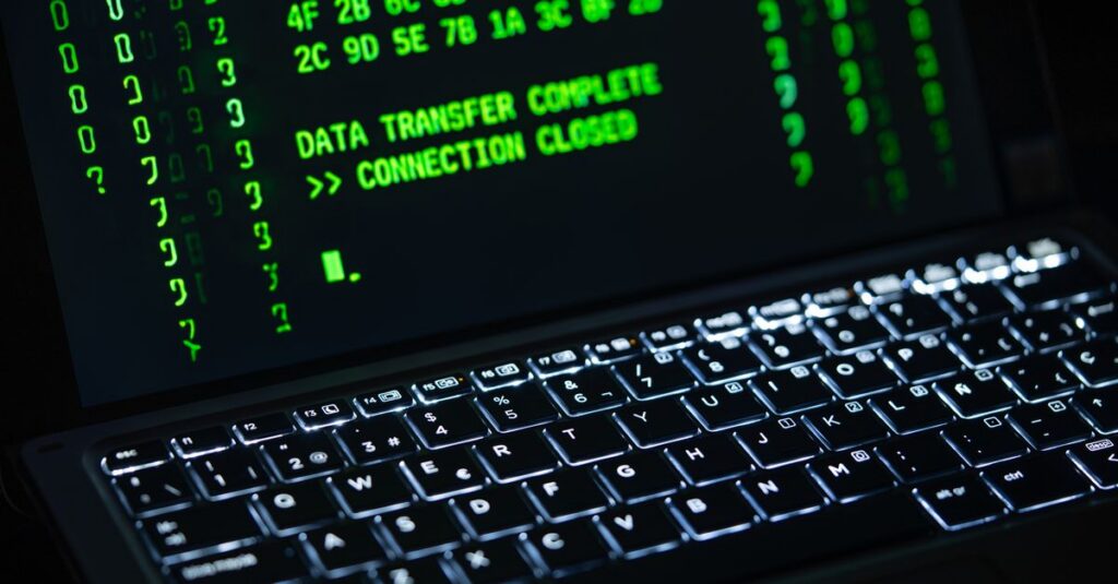 IT professional applying a software security update on a laptop in a Southwest Florida office
