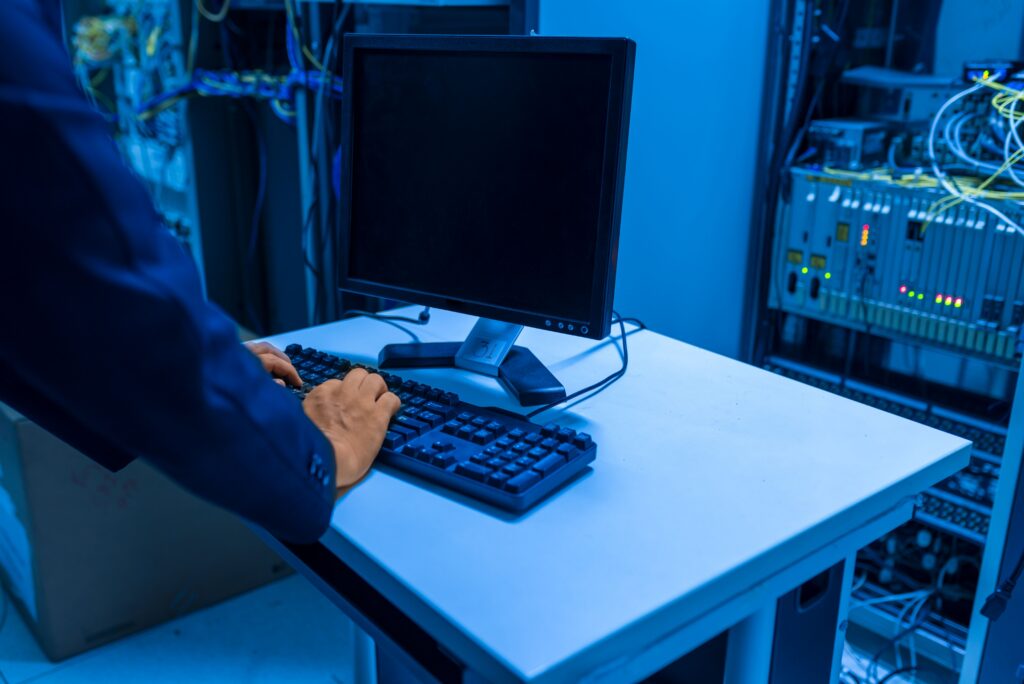 IT technician checking server equipment in a data center rack